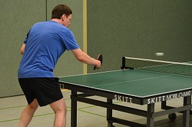 man playing ping pong