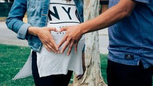 Hand on pregnant woman's belly